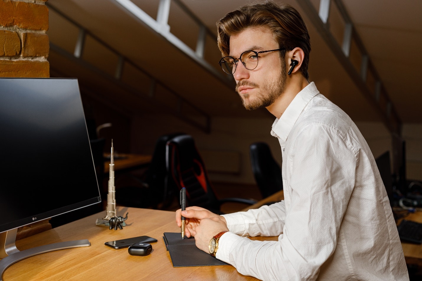 A person sitting at a desk

Description automatically generated with low confidence