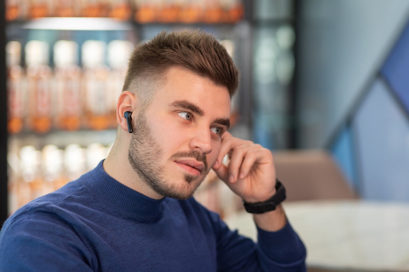 A person with a beard talking on a cell phone Description automatically generated with low confidence